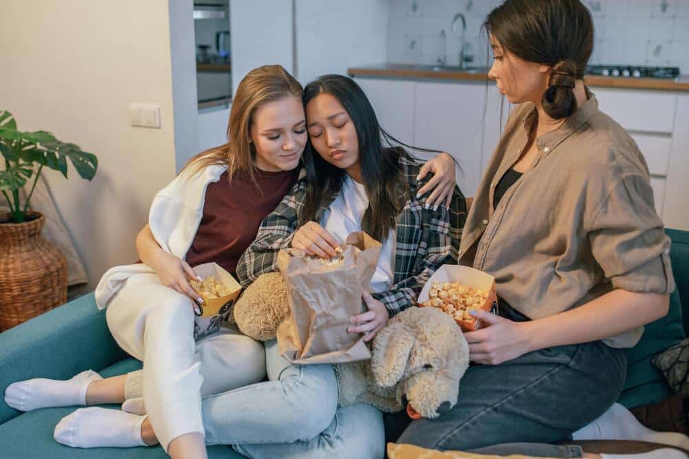Friends comforting a person after a breakup.